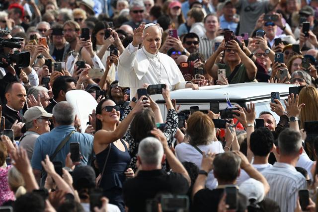 Pope Leo XIV waves to the crowd from the popemobile as he arrives for the weekly general audience at St Peter's Square, in the Vatican, on October 7, 2026. (Photo by Andreas SOLARO / AFP)