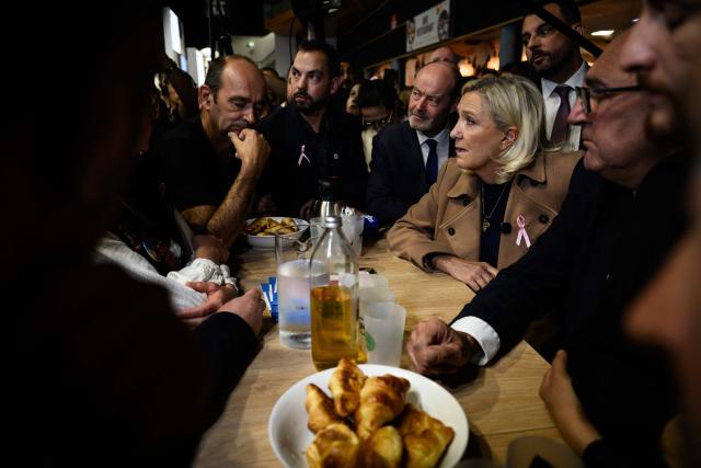 Far-right Rassemblement National (RN) presidential candidate Marine Le Pen speaks with exhibitors as she visits the Livestock Summit (Sommet de l'elevage) in Cournon-d'Auvergne, on October 7, 2026.  (Photo by JEFF PACHOUD / AFP)