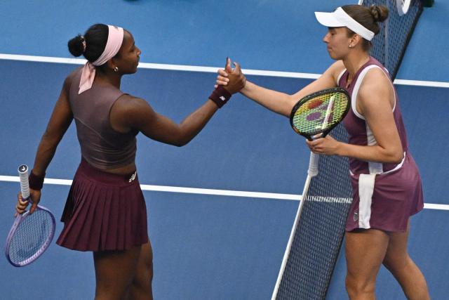 Belgium's Elise Mertens (R) shakes hands with USA's Coco Gauff after their women's singles match at the China Open tennis tournament in Beijing on October 7, 2026. (Photo by Pedro PARDO / AFP)