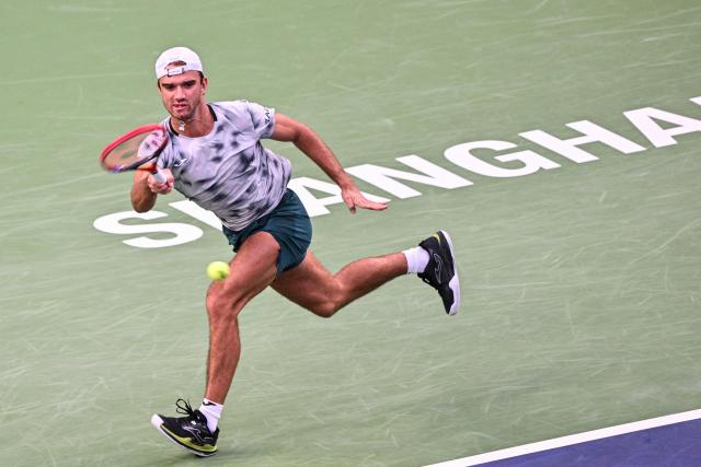 Czech Republic's Tomas Machac hits a return to China's Zhizhen Zhang during their men's singles match at the Shanghai Masters tennis tournament in Shanghai on October 7, 2026. (Photo by Hector RETAMAL / AFP)