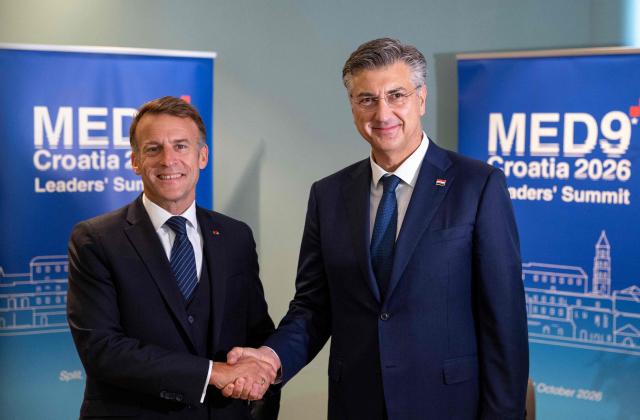 Croatia's Prime Minister Andrej Plenkovic (R) shakes hands with France's President Emmanuel Macron during the MED9 summit in Split on October 7, 2026, where the leaders of nine EU nations and invited leaders are gathering. (Photo by MARKO PERKOV / AFP)