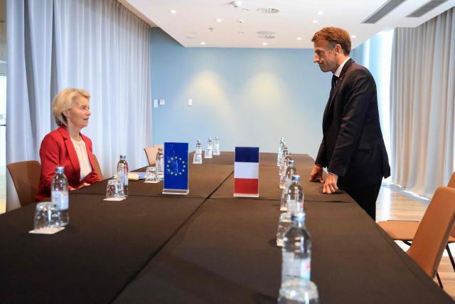 European Commission President Ursula Von der Leyen (L) and France's President Emmanuel Macron react ahead of the start of a working lunch and third session focused on the Middle East during the MED9 summit in Split on October 7, 2026, where the leaders of nine EU nations and invited leaders are gathering. (Photo by Ludovic MARIN / AFP)