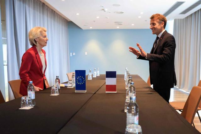 European Commission President Ursula Von der Leyen (L) and France's President Emmanuel Macron react ahead of the start of a working lunch and third session focused on the Middle East during the MED9 summit in Split on October 7, 2026, where the leaders of nine EU nations and invited leaders are gathering. (Photo by Ludovic MARIN / AFP)