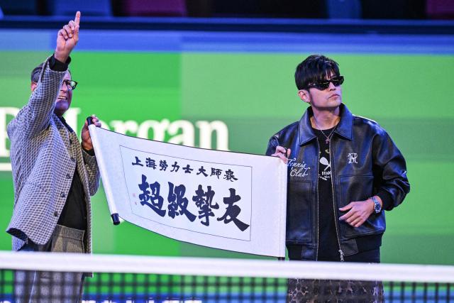 Taiwanese performer Jay Chou (R) is seen during an event at the Shanghai Masters tennis tournament in Shanghai on October 7, 2026. (Photo by Hector RETAMAL / AFP)