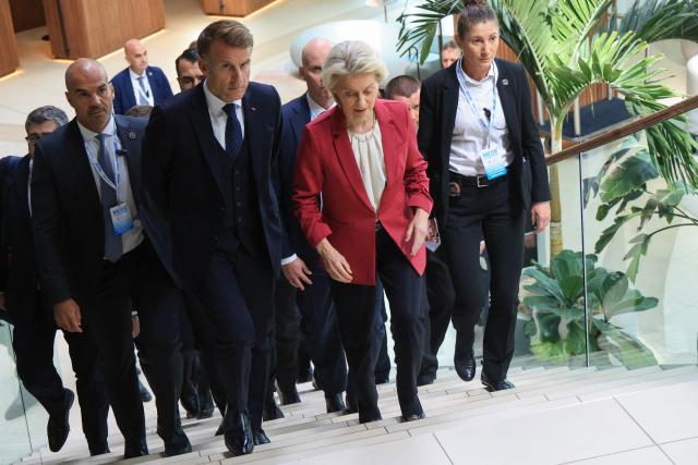 European Commission President Ursula Von der Leyen (C) and France's President Emmanuel Macron (C-L) arrive to attend a working lunch and third session focused on the Middle East during the MED9 summit in Split on October 7, 2026, where the leaders of nine EU nations and invited leaders are gathering. (Photo by Ludovic MARIN / AFP)