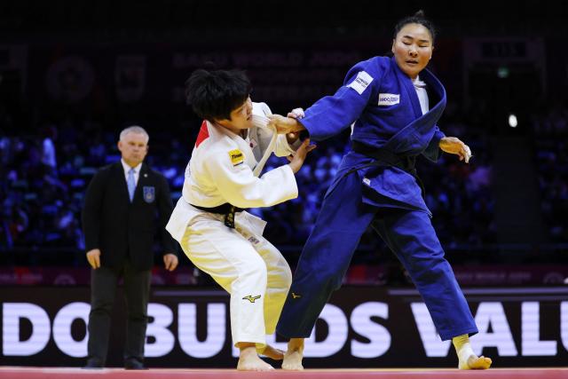 Japan's Haruka Kaju (white) competes against Mongolia's Gankhaich Bold in the women's under 63 kg quarter-final at the World Judo Championships in Baku on October 7, 2026. (Photo by Anne-Christine POUJOULAT / AFP)