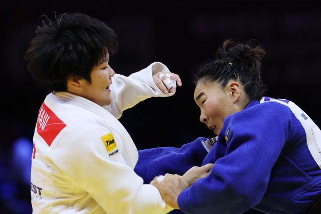 Japan's Haruka Kaju (white) competes against Mongolia's Gankhaich Bold in the women's under 63 kg quarter-final at the World Judo Championships in Baku on October 7, 2026. (Photo by Anne-Christine POUJOULAT / AFP)