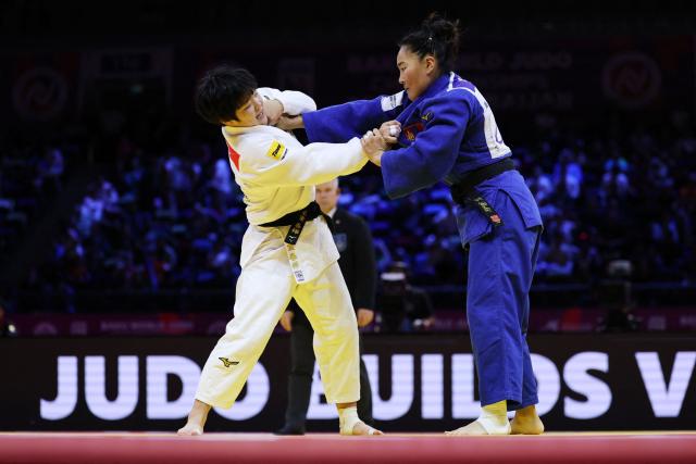Japan's Haruka Kaju (white) competes against Mongolia's Gankhaich Bold in the women's under 63 kg quarter-final at the World Judo Championships in Baku on October 7, 2026. (Photo by Anne-Christine POUJOULAT / AFP)