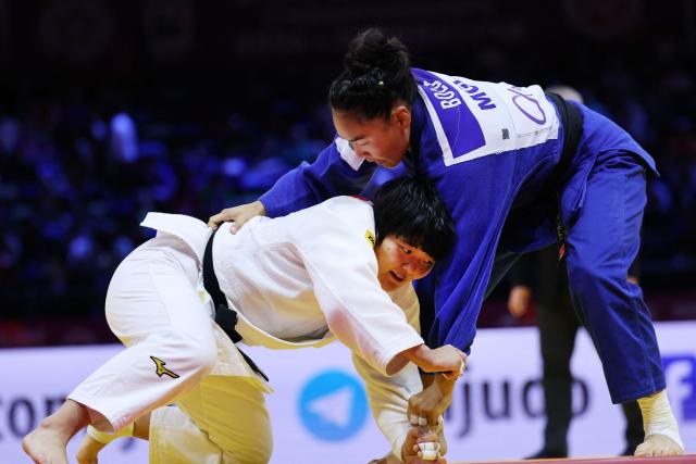 Japan's Haruka Kaju (white) competes against Mongolia's Gankhaich Bold in the women's under 63 kg quarter-final at the World Judo Championships in Baku on October 7, 2026. (Photo by Anne-Christine POUJOULAT / AFP)