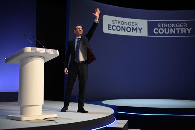 Britain's main opposition Conservative Party Shadow Home Secretary Chris Philp acknowledges the applause after addressing delegates on the final day of the annual Conservative Party conference in Birmingham, central England, on October 7, 2026.  (Photo by Oli SCARFF / AFP)
