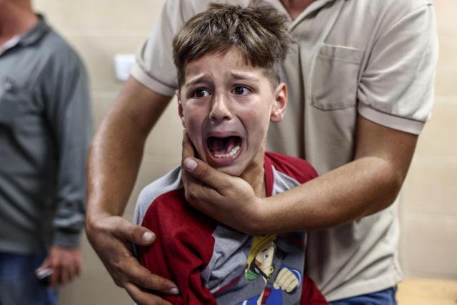 The son of Palestinian man Ali al-Bazzari mourns during his father's funeral at Rafidia Hospital in the Israeli-occupied West Bank city of Nablus after the latter was reportedly killed during an Israeli settler and army raid in the village of Burqa on October 7, 2026. (Photo by Zain JAAFAR / AFP)