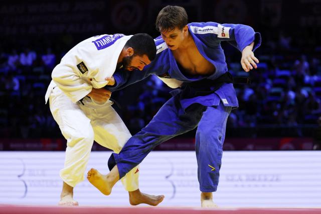 Georgia's Tato Grigalashvili (white) competes against Serbia's Mihajlo Simin in the men's under 81 kg semi-final at the World Judo Championships in Baku on October 7, 2026. (Photo by Anne-Christine POUJOULAT / AFP)