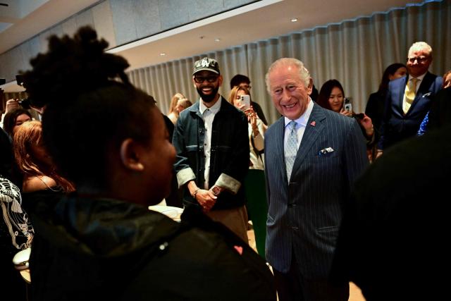 Britain's King Charles III smiles as he meets a mentor during a visit to a music workshop for young people, the first as part of the Apple x King’s Trust Creative Labs, at Battersea Power Station in south west London on October 7, 2026. (Photo by Ben STANSALL / POOL / AFP)