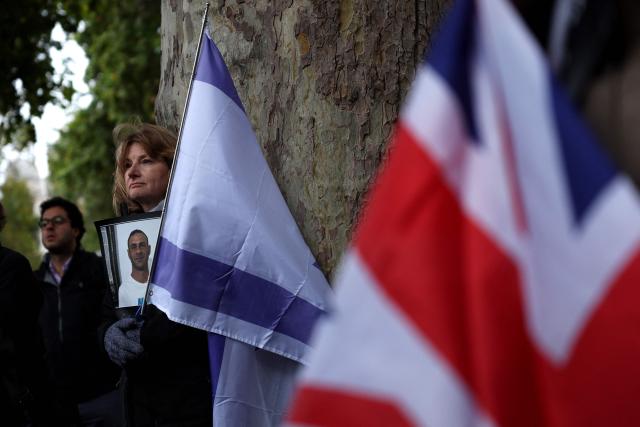 People gather before a memorial service to mark the third anniversary of the Hamas attacks on Israel, in central London on October 7, 2026. (Photo by Adrian Dennis / AFP)