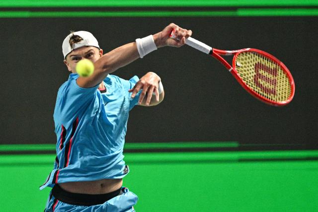 Denmark's Holger Rune hits a return to Germany's Daniel Altmaier during their men's singles match at the Shanghai Masters tennis tournament in Shanghai on October 7, 2026. (Photo by Hector RETAMAL / AFP)