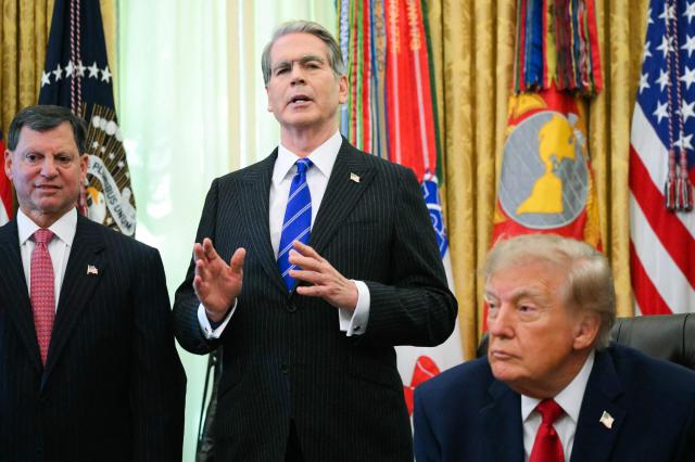 Secretary of Treasury Scott Bessent (C), alongside US President Donald Trump (R) and Social Security Administration commissioner Frank Bisignano (L), speaks about "Trump accounts," investment savings accounts for children, in the Oval Office in the White House in Washington, DC on October 7, 2026. (Photo by Alex WROBLEWSKI / AFP)