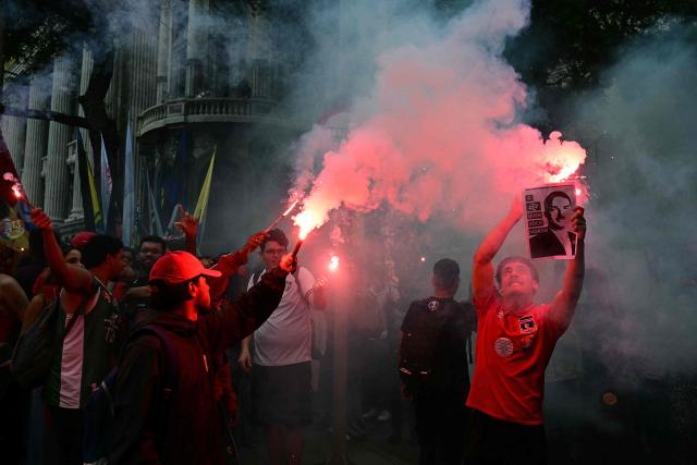 Students backing Brazil's President and presidential candidate Luiz Inacio Lula da Silva for the runoff election light flares during a march against the far right, in Rio de Janeiro, Brazil on October 7, 2026. Lula da Silva, who has risen from the political ashes several times, is heading to a runoff election against right-wing senator Flavio Bolsonaro on October 25, after a shock second-place finish in the first-round vote. (Photo by Pablo PORCIUNCULA / AFP)
