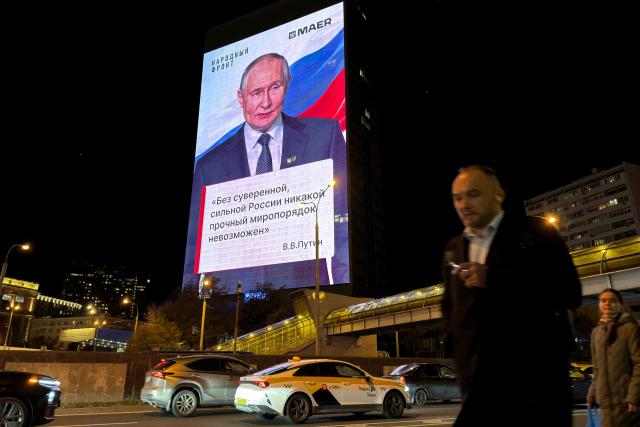 A huge advertising screen displays a portrait of Russian President Vladimir Putin and an inscription reading "A stable world order is impossible without a sovereign, strong Russia" in Moscow on October 7, 2026. (Photo by Andrey BORODULIN / AFP)