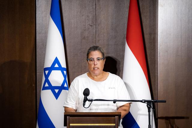 Resident of the Kibbutz Kfar Aza, Rotem Holin, shares her experiences of Hammas' October 7 attack during a memorial service for the victims on the third anniversary of the attack, at the Amsterdam Modern Orthodox Synagogue, in Amsterdam, on October 7, 2026. (Photo by Ramon van Flymen / ANP / AFP) / Netherlands OUT