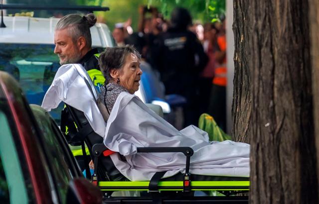 Maricarmen Abascal, an 87-year-old pensioner, is taken on a stretcher as she was evicted from her Madrid home, on September 23, 2026. Abascal, whose eviction triggered nationwide protests over Spain's chronic housing crisis and a political debate that culminated in early elections died on Wednesday, a tenants' union said. Abascal became a symbol of Spain's housing market on September 23 when she was evicted from her life-long Madrid home on a stretcher after the real estate firm that owned the apartment drastically hiked the rent. (Photo by DANI DUCH / LA VANGUARDIA / AFP) / Spain OUT / MANDATORY CREDIT "DANI DUCH - LA VANGUARDIA"