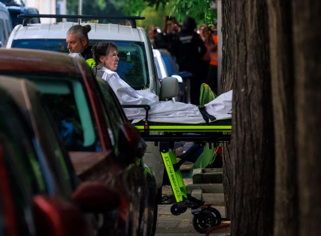 Maricarmen Abascal, an 87-year-old pensioner, is taken on a stretcher as she was evicted from her Madrid home, on September 23, 2026. Abascal, whose eviction triggered nationwide protests over Spain's chronic housing crisis and a political debate that culminated in early elections died on Wednesday, a tenants' union said. Abascal became a symbol of Spain's housing market on September 23 when she was evicted from her life-long Madrid home on a stretcher after the real estate firm that owned the apartment drastically hiked the rent. (Photo by DANI DUCH / LA VANGUARDIA / AFP) / Spain OUT / MANDATORY CREDIT "DANI DUCH - LA VANGUARDIA"