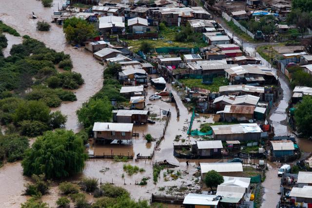 This aerial view shows a flooded area following the overflow of the Mapocho River in Talagante, Metropolitan Region, Chile, on October 7, 2026. (Photo by Javier TORRES / AFP)