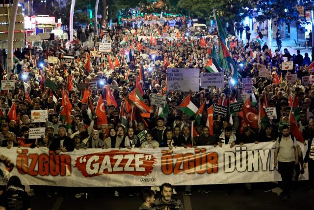 Demonstrators hold a banner reading "Free Gaza, free world" as they take part in a pro-Palestinian march in Ankara on October 7, 2026 on the third anniversary of Hamas' 2023 attacks against Israel known as "Operation Aqsa Flood". (Photo by Adem ALTAN / AFP)