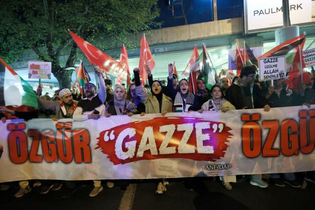 Demonstrators hold a banner reading "Free Gaza, free world" as they take part in a pro-Palestinian march in Ankara on October 7, 2026 on the third anniversary of Hamas' 2023 attacks against Israel known as "Operation Aqsa Flood". (Photo by ADEM ALTAN / AFP)