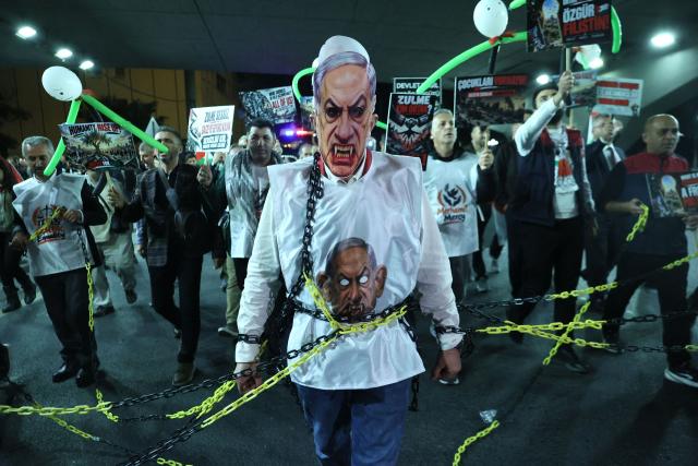 A protester wears a mask depicting Israeli Prime Minister Benjamin Netanyahu during a pro-Palestinian march in Ankara on October 7, 2026 on the third anniversary of Hamas' 2023 attacks against Israel known as "Operation Aqsa Flood". (Photo by ADEM ALTAN / AFP)