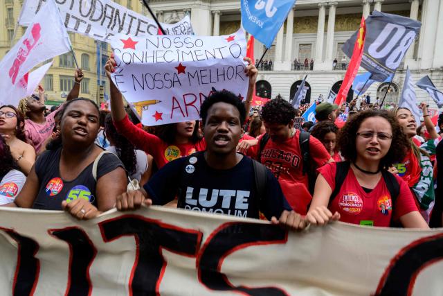 Students backing Brazil's President and presidential candidate Luiz Inacio Lula da Silva in the runoff election take part in a march against the far right in Rio de Janeiro, Brazil on October 7, 2026. Lula da Silva, who has risen from the political ashes several times, is heading to a runoff election against right-wing senator Flavio Bolsonaro on October 25, after a shock second-place finish in the first-round vote. (Photo by Pablo PORCIUNCULA / AFP)