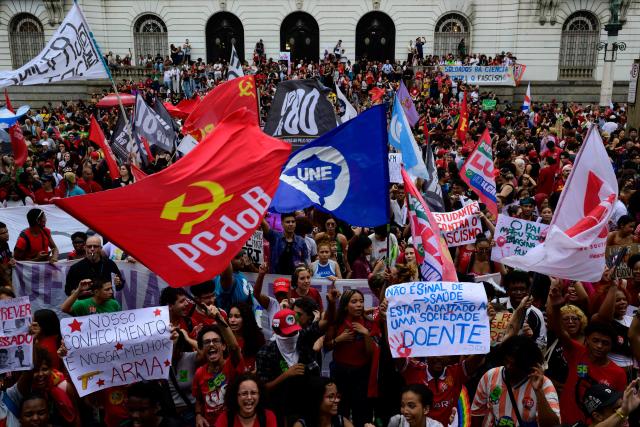 Students backing Brazil's President and presidential candidate Luiz Inacio Lula da Silva in the runoff election take part in a march against the far right in Rio de Janeiro, Brazil, on October 7, 2026. Lula da Silva, who has risen from the political ashes several times, is heading to a runoff election against right-wing senator Flavio Bolsonaro on October 25, after a shock second-place finish in the first-round vote. (Photo by Pablo PORCIUNCULA / AFP)