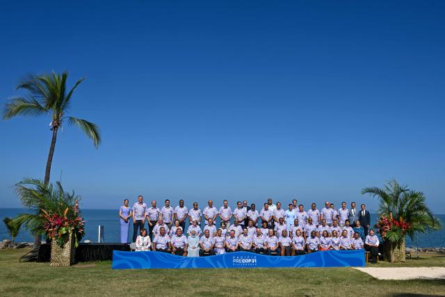 Pose for a family photo at the conclusion of the final day of the Pacific Pre-COP31 Summit in Nadi on October 8, 2026. This week's "pre-COP" meetings in the Fijian city of Nadi are a precursor to the larger UN-sponsored global climate summit -- known as COP31 -- to be held in Turkey next month. (Photo by SAEED KHAN / AFP)