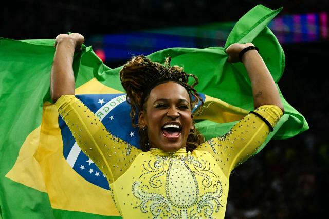 (FILES) Second-placed Brazil's Rebeca Andrade celebrates after the artistic gymnastics women's all around final during the Paris 2024 Olympic Games at the Bercy Arena in Paris, on August 1, 2024. Brazilian Olympic champion Rebeca Andrade will return to competition at the artistic gymnastics world championships after missing last year's edition during a career break taken for mental health reasons, the country's gymnastics confederation said on October 7, 2026. (Photo by Loic VENANCE / AFP)