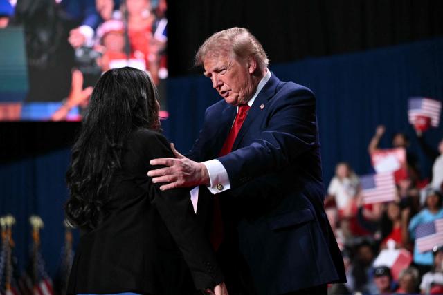 US President Donald Trump (R) embraces Marie Vega, mother of Javier Vega Jr, as he attends a campaign rally at the Freeman Coliseum in San Antonio, Texas, on October 7, 2026. Republican Senate candidate Ken Paxton is in a close race with Democratic candidate James Talarico for one of Texas' US Senate seats. (Photo by Mandel NGAN / AFP)