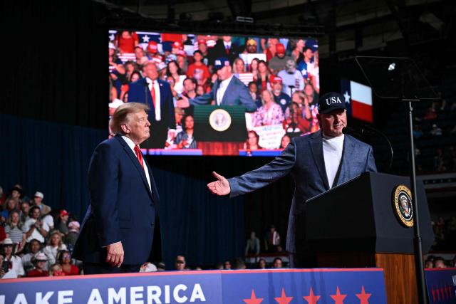 US President Donald Trump listens as former MLB player Roger Clemens (R) speaks at a campaign rally at the Freeman Coliseum in San Antonio, Texas, on October 7, 2026. Republican Senate candidate Ken Paxton is in a close race with Democratic candidate James Talarico for one of Texas' US Senate seats. (Photo by Mandel NGAN / AFP)