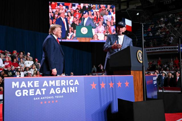 US President Donald Trump listens as former MLB player Roger Clemens (R) speaks at a campaign rally at the Freeman Coliseum in San Antonio, Texas, on October 7, 2026. Republican Senate candidate Ken Paxton is in a close race with Democratic candidate James Talarico for one of Texas' US Senate seats. (Photo by Mandel NGAN / AFP)