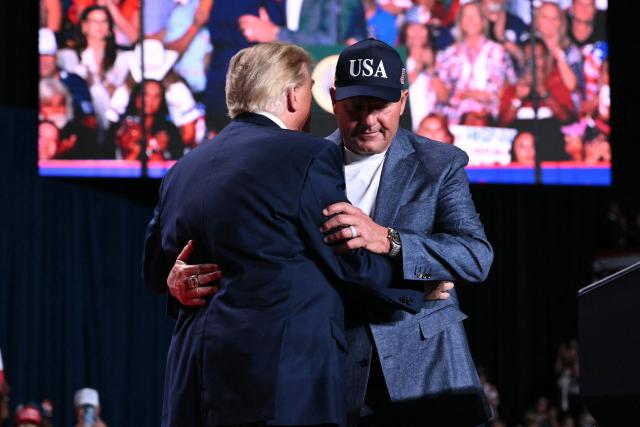 US President Donald Trump embraces former MLB player Roger Clemens (R) during a campaign rally at the Freeman Coliseum in San Antonio, Texas, on October 7, 2026. Republican Senate candidate Ken Paxton is in a close race with Democratic candidate James Talarico for one of Texas' US Senate seats. (Photo by Mandel NGAN / AFP)