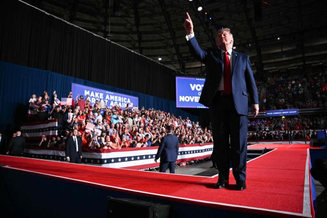 US President Donald Trump signals to the crowd during a campaign rally at the Freeman Coliseum in San Antonio, Texas, on October 7, 2026. Republican Senate candidate Ken Paxton is in a close race with Democratic candidate James Talarico for one of Texas' US Senate seats. (Photo by Mandel NGAN / AFP)