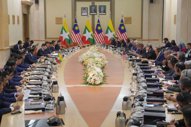 Myanmar’s President Min Aung Hlaing (centre L) and Malaysia’s Prime Minister Anwar Ibrahim (centre R) attend a meeting in Putrajaya on October 8, 2026. (Photo by Azneal Ishak / POOL / AFP)