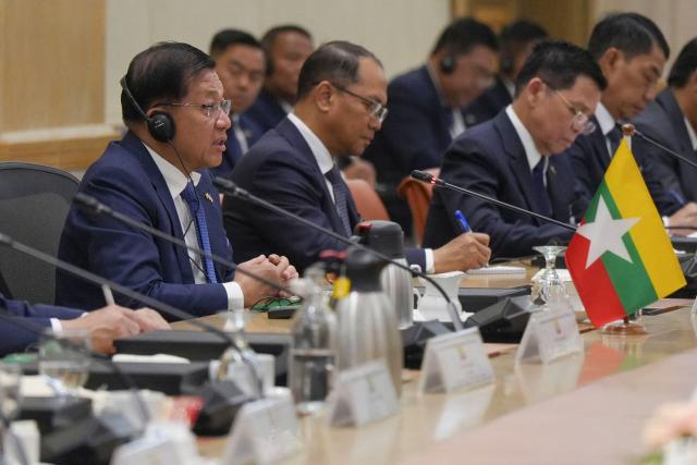 Myanmar’s President Min Aung Hlaing (L) speaks during a meeting with Malaysia’s Prime Minister Anwar Ibrahim in Putrajaya on October 8, 2026. (Photo by Azneal Ishak / POOL / AFP)