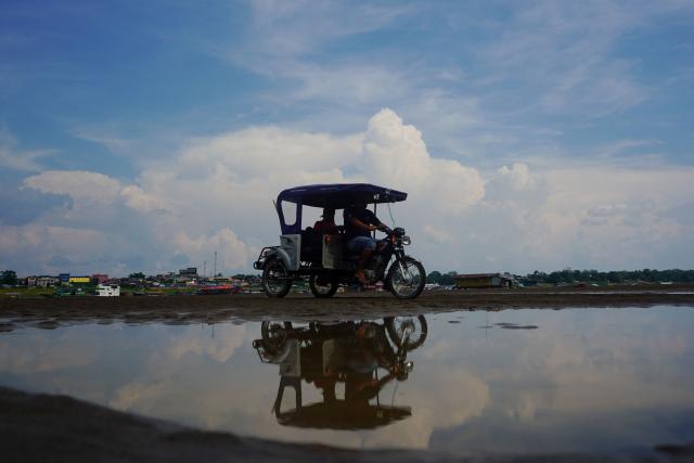 A mototaxi travels along the banks of the Amazon River in Santa Rosa de Yavari, Peru, on October 7, 2026. (Photo by Pablo VERA / AFP)