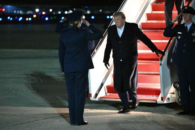 US President Donald Trump steps off Air Force One upon arrival at Joint Base Andrews, Maryland in the early hours of October 8, 2026. Trump is returning from San Antonio, Texas where he spoke at a midterm elections campaign rally. (Photo by Mandel NGAN / AFP)