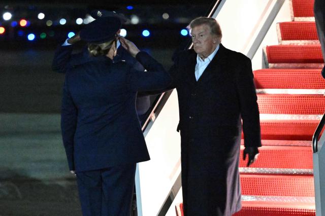 US President Donald Trump steps off Air Force One upon arrival at Joint Base Andrews, Maryland in the early hours of October 8, 2026. Trump is returning from San Antonio, Texas where he spoke at a midterm elections campaign rally. (Photo by Mandel NGAN / AFP)