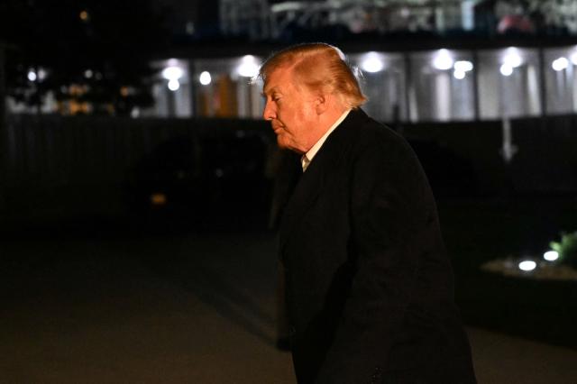 US President Donald Trump walks from the South Lawn of the White House after his arrival aboard Marine One to Washington, DC, in the early hours of October 8, 2026. Trump is returning from San Antonio, Texas where he spoke at a midterm elections campaign rally. (Photo by Alex WROBLEWSKI / AFP)