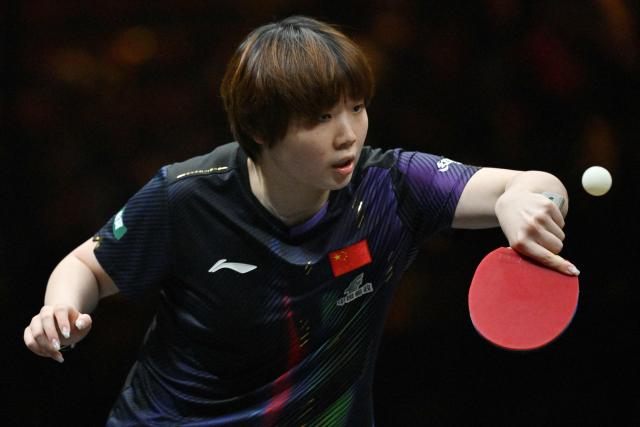 China’s Kuai Man hits a return to compatriot Zhu Sibing during their women’s singles match at the China Smash table tennis tournament in Beijing on October 8, 2026. (Photo by ADEK BERRY / AFP)