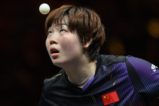 China’s Kuai Man serves to compatriot Zhu Sibing during their women’s singles match at the China Smash table tennis tournament in Beijing on October 8, 2026. (Photo by ADEK BERRY / AFP)