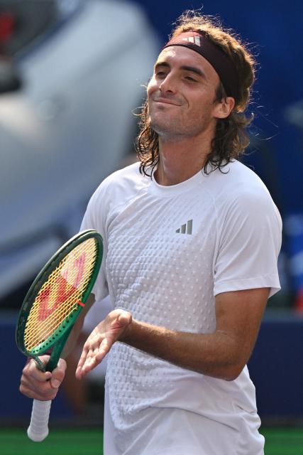 Greece's Stefanos Tsitsipas celebrates after his victory against Belgium's Kimmer Coppejans during their men's singles match at the Shanghai Masters tennis tournament in Shanghai on October 8, 2026. (Photo by Hector RETAMAL / AFP)