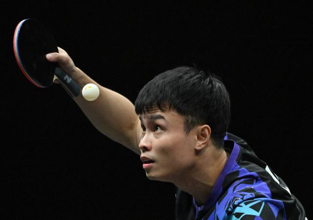 China’s Zhou Qihao serves to Japan’s Tomokazu Harimoto during their men’s singles match at the WTT China Smash table tennis tournament in Beijing on October 8, 2026. (Photo by ADEK BERRY / AFP)