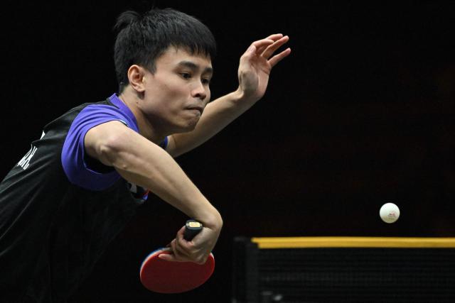 China’s Zhou Qihao hits a return to Japan’s Tomokazu Harimoto during their men’s singles match at the WTT China Smash table tennis tournament in Beijing on October 8, 2026. (Photo by ADEK BERRY / AFP)