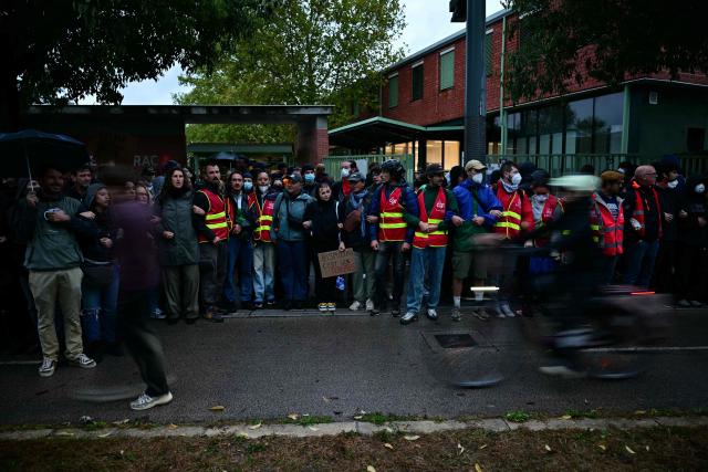 Members of French trade union General Confederation of Labour (CGT) stand with protesters during a blockade of high-school Deodat de Severac in Toulouse, on October 8, 2026, as part of a nationwide protest movement over learning conditions. Since late September, pupils have barred the entrances to hundreds of schools, complaining of teacher absences, overloaded timetables, dilapidated classrooms and buildings ill-adapted to rising temperatures, among other grievances. (Photo by Lionel BONAVENTURE / AFP)